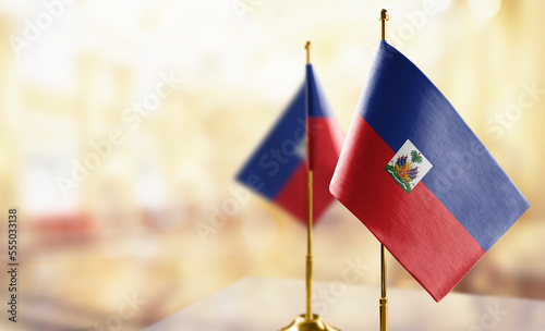Small flags of the Haiti on an abstract blurry background