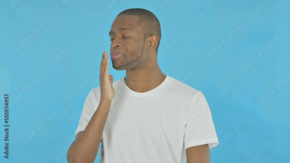 Yawning African Man on Blue Background Yawning African Man on Blue Background