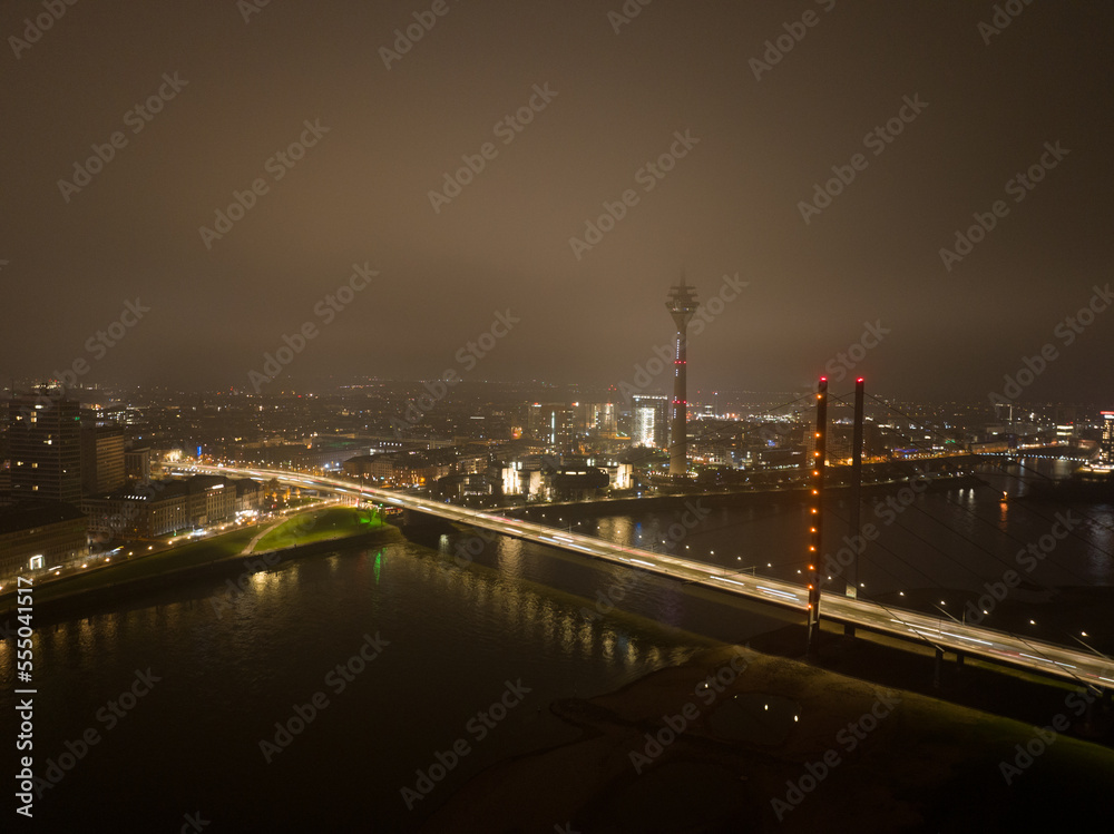 Dusseldorf skyline city overhead view, river rhine, Rheinknie bridge, Rheinturm observation tourist attraction and broadcasting tower. Aerial drone view.