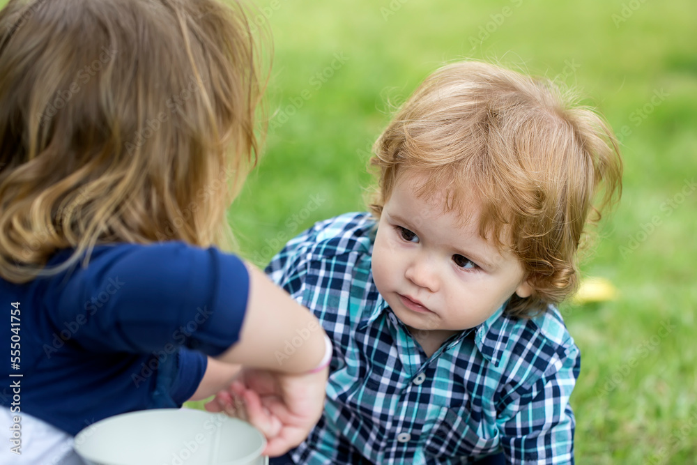 Portrait of cute little caucasian boy having fun in garden. Child on green grass lawn during walk in yard. Happy childhood and baby healthcare. Portrait of cute little caucasian boy having fun in garden. Child on green grass lawn during walk in yard. Happy childhood and baby healthcare.