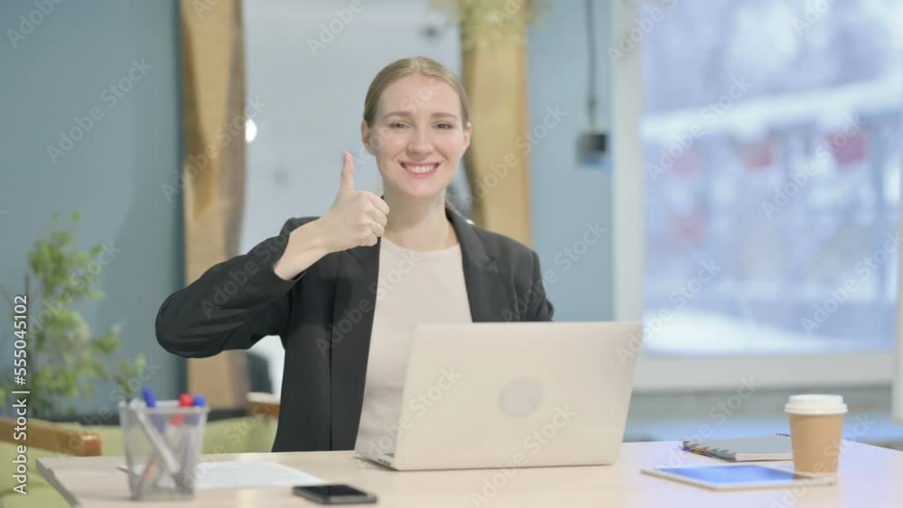 Thumbs Up by Businesswoman Working on Laptop Thumbs Up by Businesswoman Working on Laptop