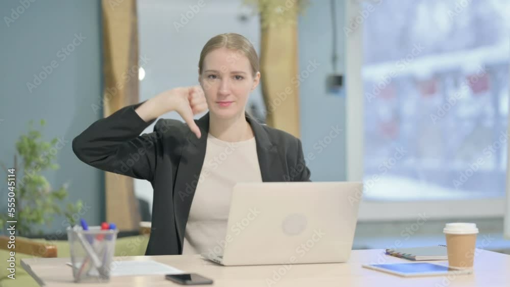 Thumbs Down by Businesswoman Working on Laptop Thumbs Down by Businesswoman Working on Laptop