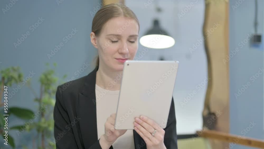 Businesswoman Browsing Internet on Digital Tablet Businesswoman Browsing Internet on Digital Tablet