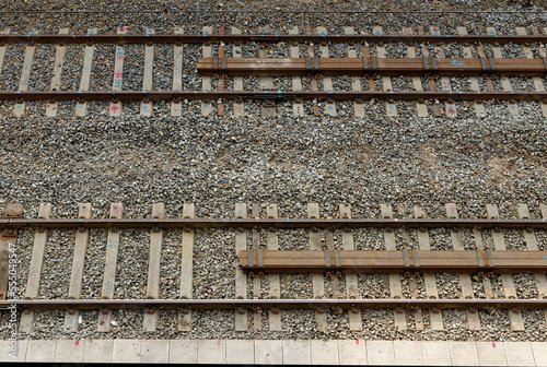 Details of two train tracks at the platform of the railway station.