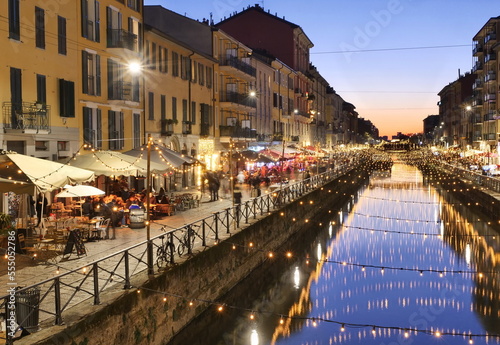 View of the crowded Naviglio Grande district in Milan and christmas lights.