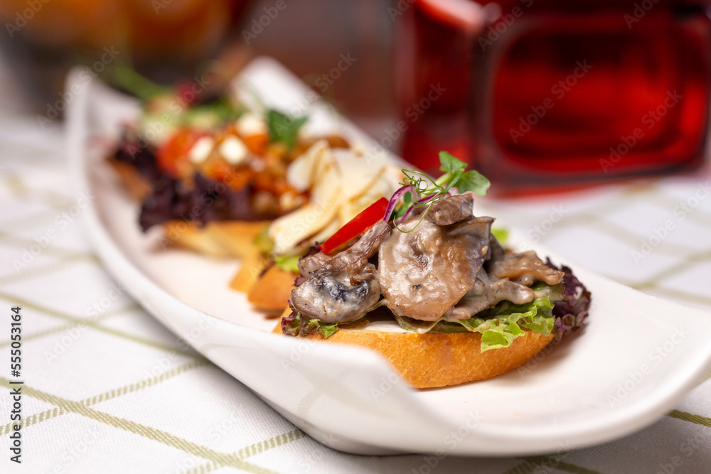 assorted bruschetta with different flavors on a white plate on the table