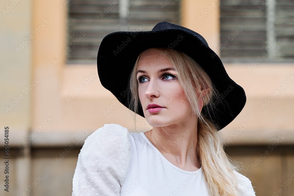 Portrait of a stylish blonde woman with a hat outdoors Portrait of a stylish blonde woman with a hat outdoors