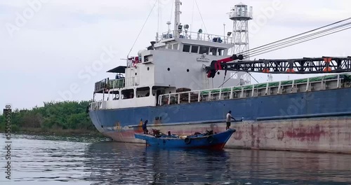 The vessel BHAITA PERKASA (IMO: 8604319, MMSI 525013011) is a General Cargo Ship built in 1986 (36 years old) and currently sailing under the flag of Indonesia. fishing boats pass underneath photo