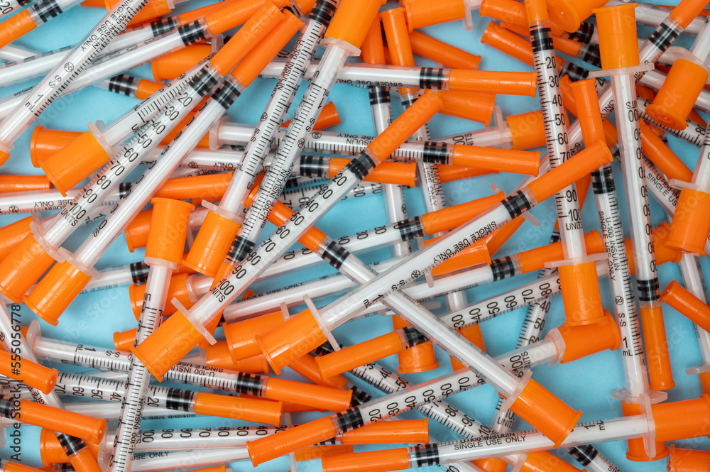 Pile of insulin needles with orange caps