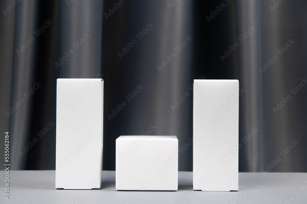 white packaging for cosmetics on a gray background white packaging for cosmetics on a gray background