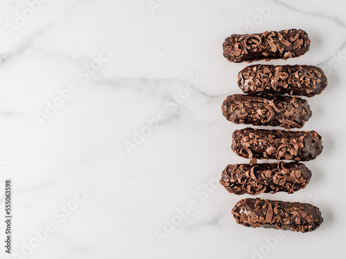 Healthy chocolate eclairs on marble background photo