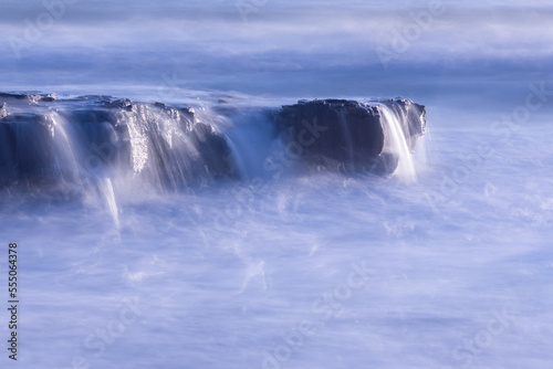 time lapse of waves over sea rocks