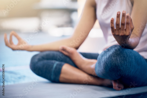 Yoga, zen and woman doing a meditation exercise in gym with lotus pose for calm, peace and balance. Mindfulness, energy and girl doing pilates workout for mind, body and spiritual health and wellness