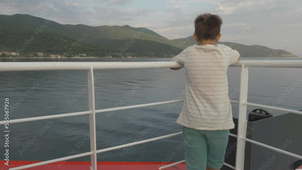 Boy watching the sea from the top of cruise ship