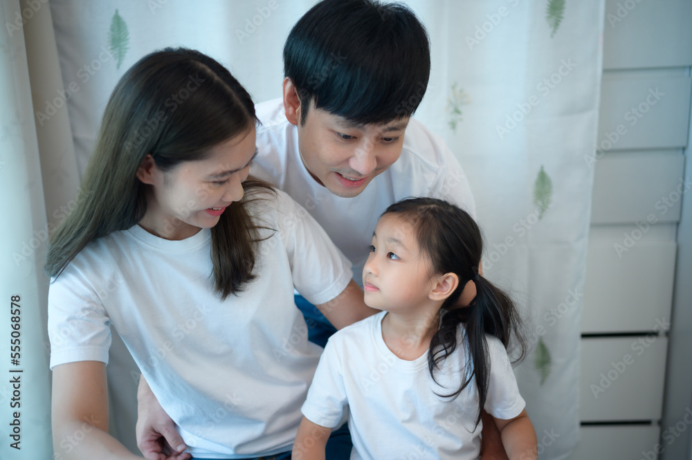 Family vacation, father and mother helping daughter practice in her piano lessons Family vacation, father and mother helping daughter practice in her piano lessons