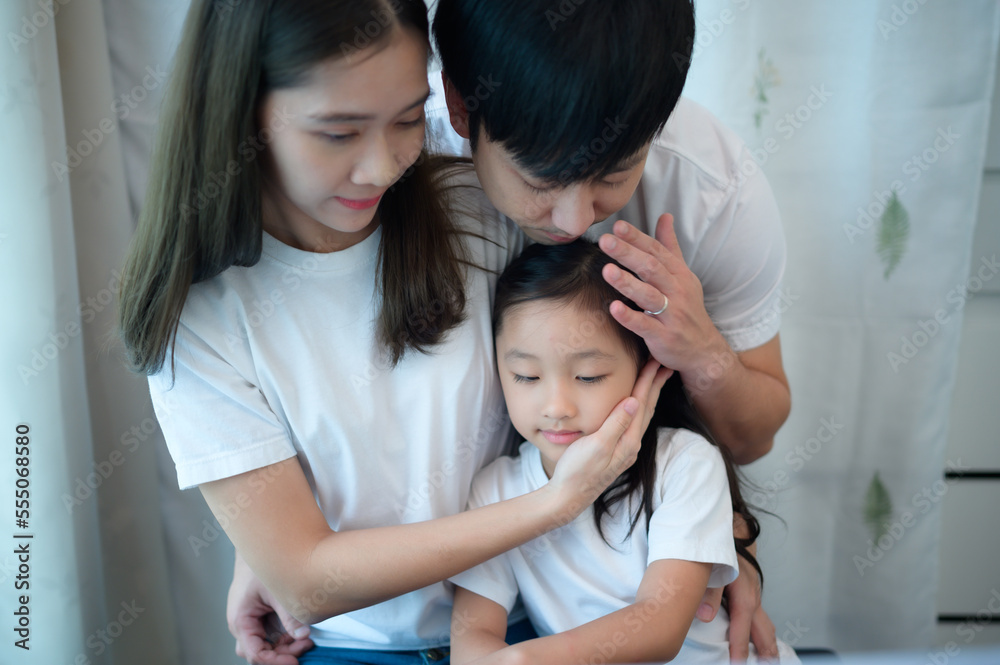 Family vacation, father and mother helping daughter practice in her piano lessons Family vacation, father and mother helping daughter practice in her piano lessons