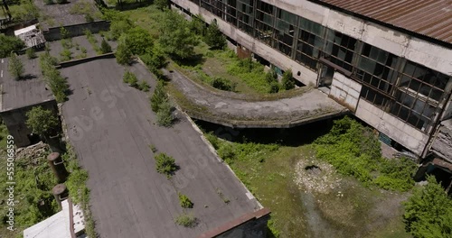 Shattered Windows Of An Old Manufacturing Building In Khashuri, Georgia. aerial pullback photo