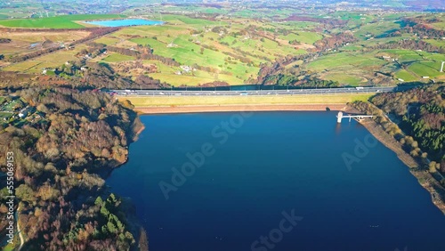 Winter aerial footage scene of  Scammonden Reservoir with the M62 motorway bridge. West Yorkshire, England. With blue water and frosty fields. photo