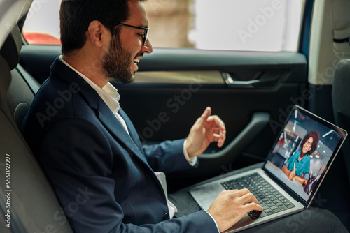 Businessman have a business meeting via video call while riding in car to office © Kostiantyn