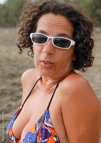 portrait of mature woman with sunglasses on the beach
