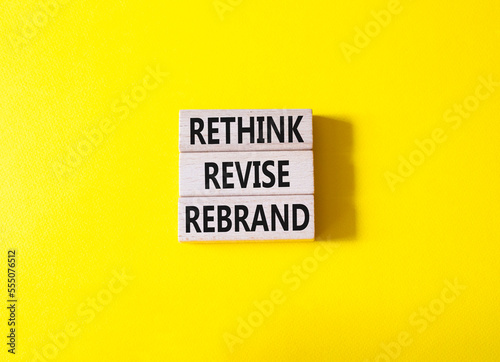 Rethink Revise Rebrand symbol. Wooden blocks with words Rethink Revise Rebrand. Beautiful yellow background. Business and Rethink Revise Rebrand concept. Copy space. photo