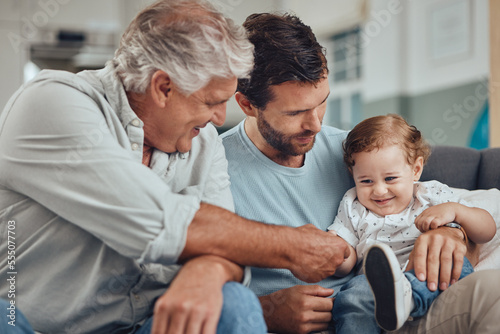 Family, father and grandfather play with baby in home, having fun and bonding. Love, care and man with grandpa holding hand of happy child, playing and enjoying quality time together in living room.