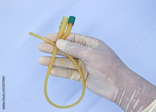 Foto nurse holding urinary catheter prior to use.