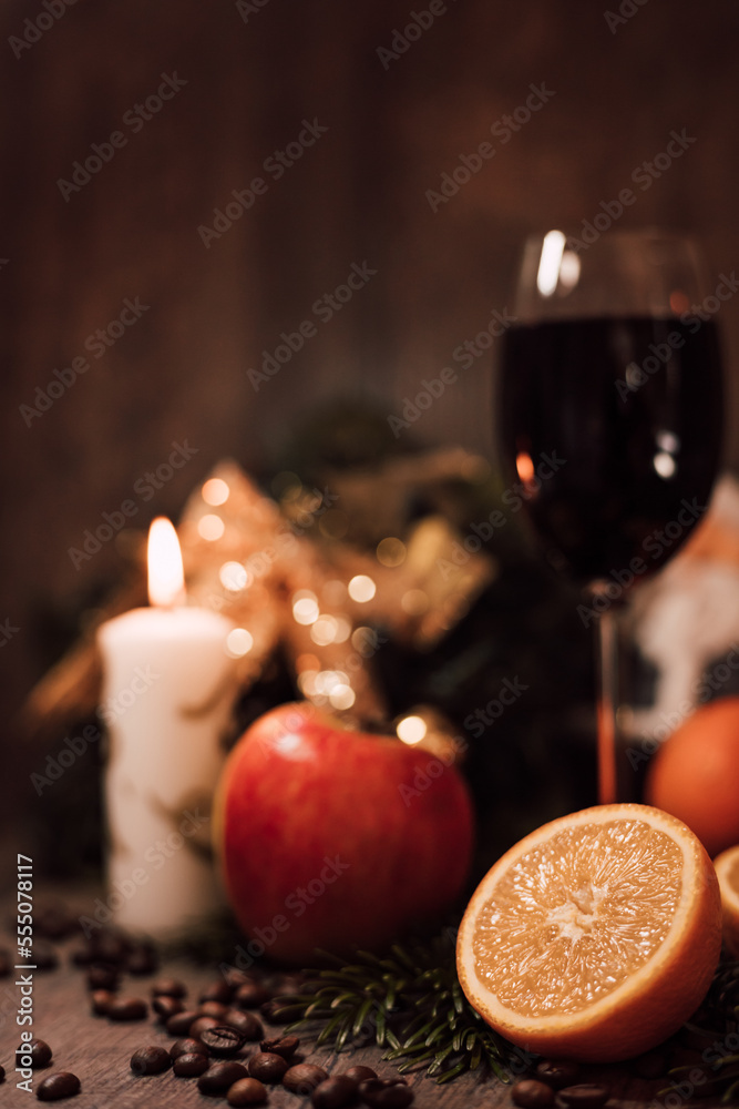 Christmas composition coffee beans, orange, wine, candle. New Year's table