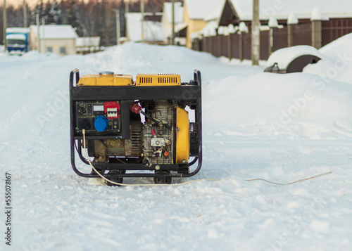 natural light. shallow depth of field. snow. an autonomous generator for generating electricity. close-up