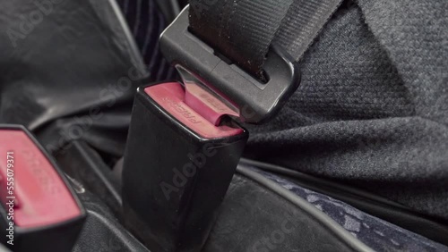 A person fastens a seat belt in transport. Seat belt in the car. Action with safety belt lock