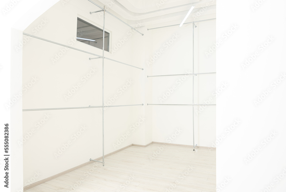 Metal pipes near white walls in empty office room. Interior design Metal pipes near white walls in empty office room. Interior design
