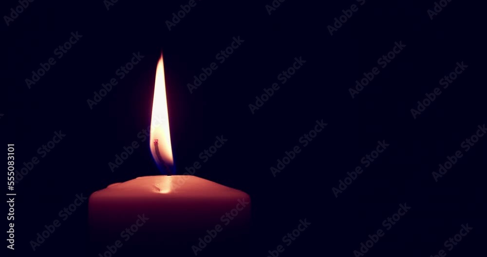 Single big yellow candle flame lights and extinguish, isolated on a black background. Slow motion and close up. Single big yellow candle flame lights and extinguish, isolated on a black background. Slow motion and close up.