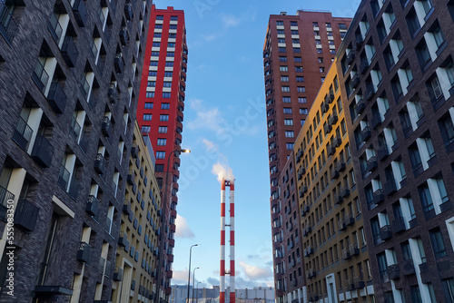 City ecology  chimneys with smoke and residential buildings in modern block