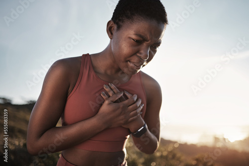 Black woman  runner and heart attack pain in nature while running outdoors. Sports  cardiovascular emergency and female athlete with chest pain  stroke or cardiac arrest after intense cardio workout.