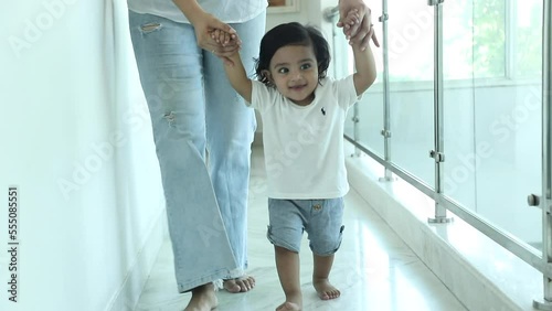 Stock video of Infant doing first steps at home.