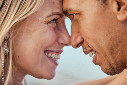 Love, diversity and couple with heads together, smile and affection touching and eye contact. Romance, trust and support woman and man touch forehead, happy couple in romantic embrace on honeymoon.