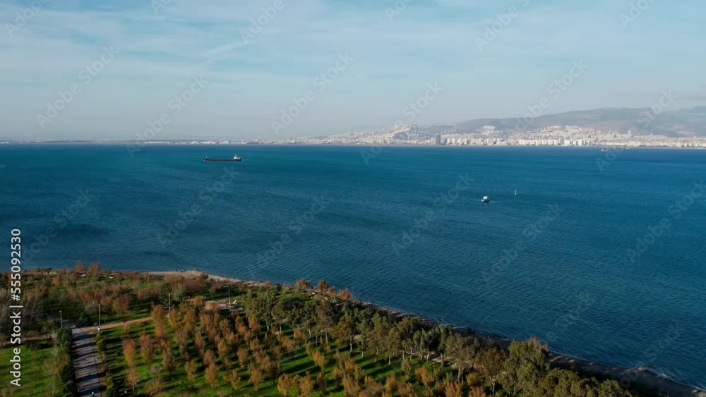 Panoramic aerial view of Izmir at sunset. Ferries, cargo ships and sailboats on the Gulf of Izmir. Panoramic aerial view of Izmir at sunset. Ferries, cargo ships and sailboats on the Gulf of Izmir.