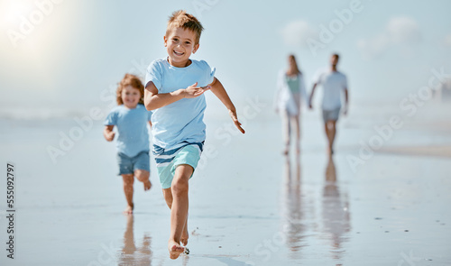 Kids, running and beach with a family on holiday or summer vacation together outdoor in nature. Children, travel and tourism with a brother and sister racing on the sand by the sea or ocean