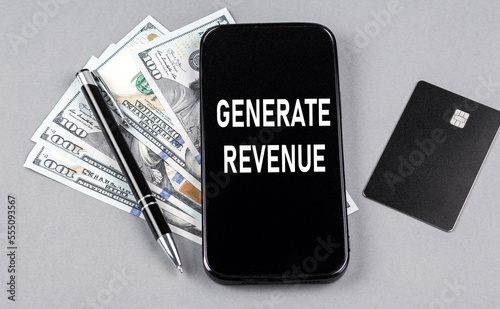 Credit card and text GENERATE REVENUE on smartphone with dollars and pen. Business concept