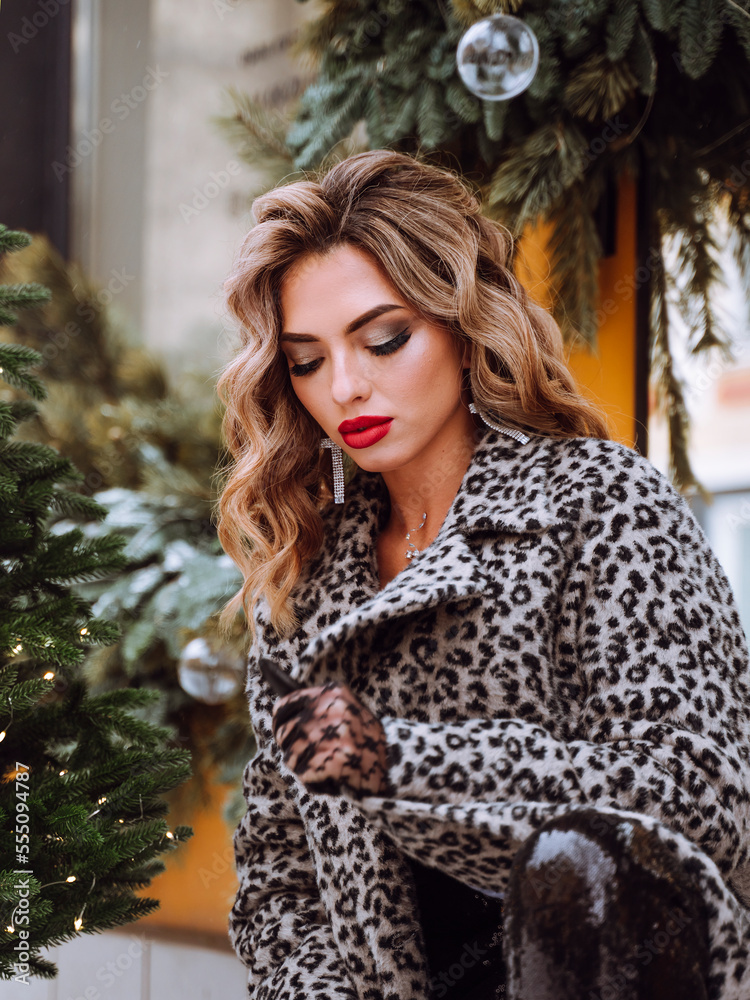 Bright young woman with long hair on the street at new year.Festive decoration of city streets. Vertical. Bright young woman with long hair on the street at new year.Festive decoration of city streets. Vertical.
