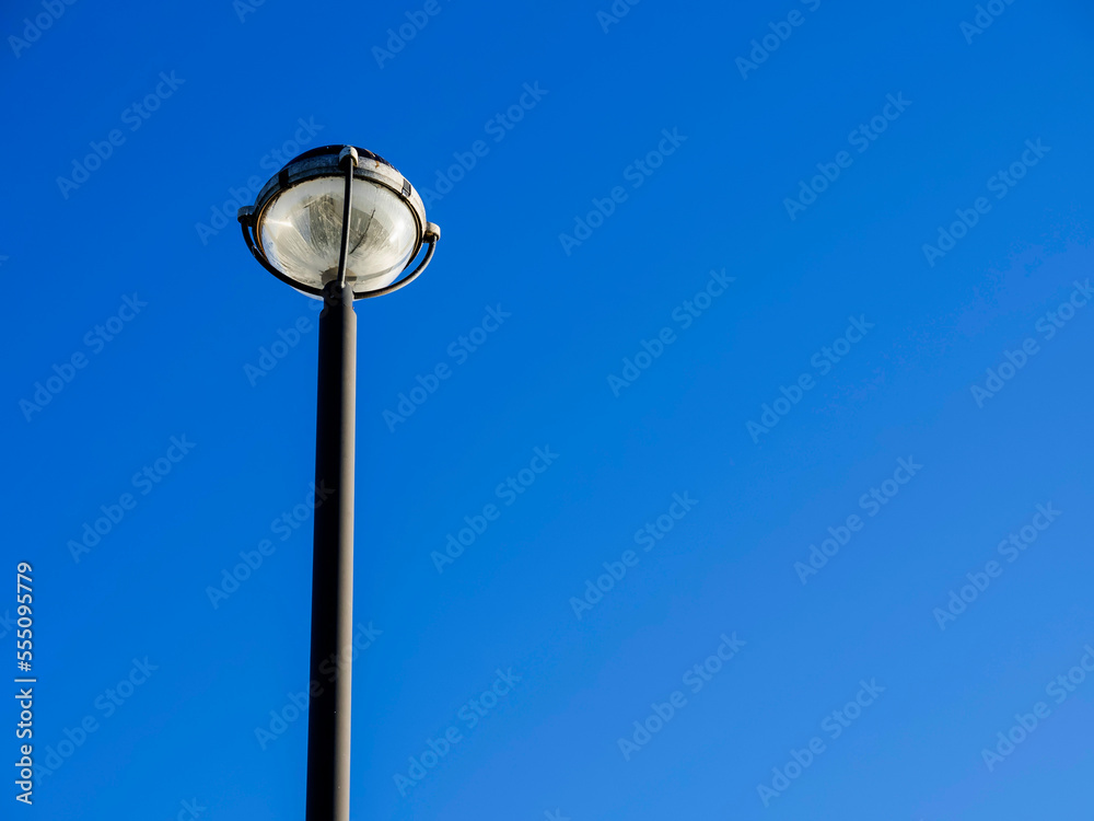 Street LED lantern against blue cloudy sky. Copy space. City illumination.
