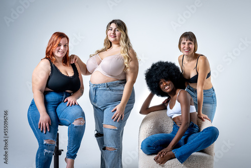 Body Positive and Acceptance, multiracial group of women  posing together to show the diversity of femaleness, curvy, plus size and skinny kind of female body concept photo