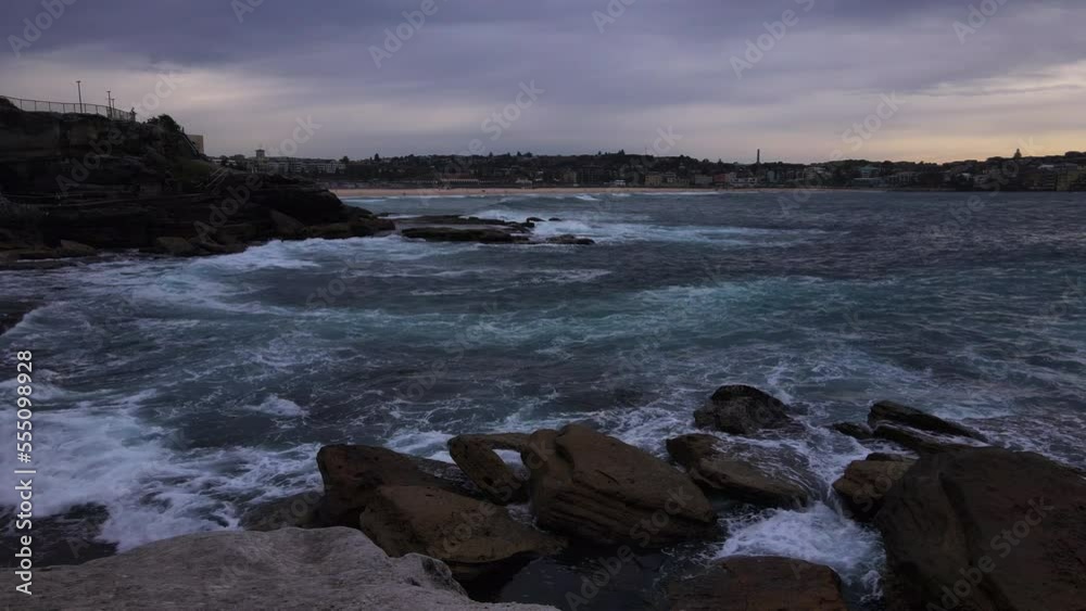 Waves crashing on rocks stormy sky white foam Waves crashing on rocks stormy sky white foam
