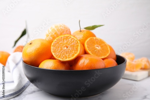 Fototapeta Naklejka Na Ścianę i Meble -  Fresh juicy tangerines on white marble table