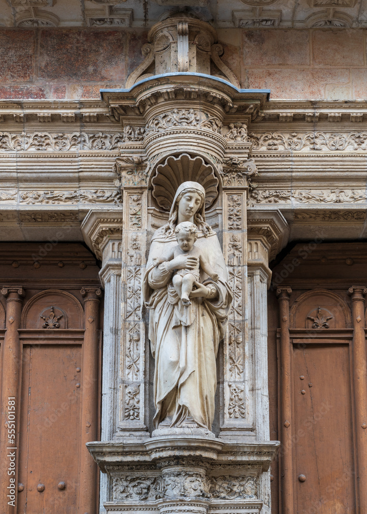 Ancient Virgin and Child stone statue at the entrance portal of Notre Dame de la Dalbade church, Toulouse, France
