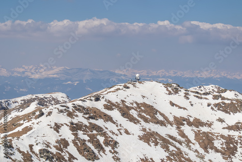 Panoramic view of radar station on snow covered mountain peak Scharfes Eck seen from top of Zirbitzkogel, Seetal Alps, Styria, Austria, Europe. Panoramic view on snowcapped ridges of Ennstaler Alps