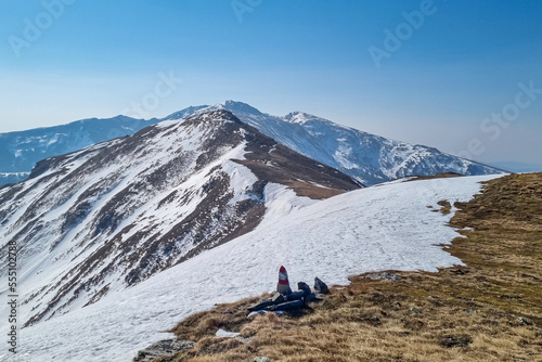 Snow covered alpine pasture with panoramic view on snow capped mountain peak Zirbitzkogel and Kreiskogel in Seetal Alps, Styria, Austria, Europe. Hiking trail Central Alps in winter on sunny day © Chris