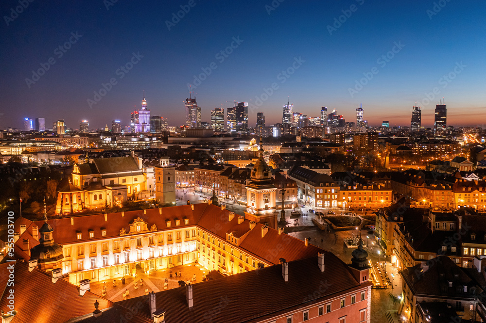 Warsaw Royal Castle and city center at dusk, aerial view of clear evening blue sky over old town
