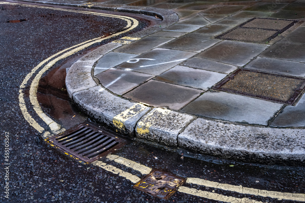 Double yellow lines on a curved kerb in London StockFoto Adobe Stock