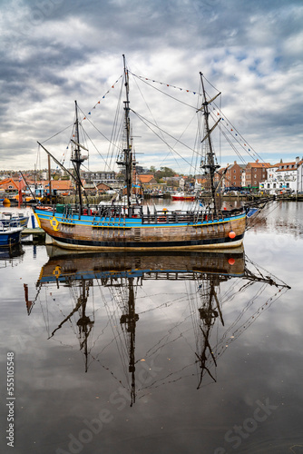 Old galleon reflected in a harbour